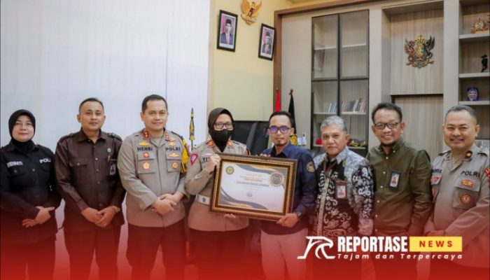 Kapolres Sumenep, AKBP Henri Noveri Santoso, bersama Kasat Lantas, AKP Ninit Titis saat menerima penghargaan dari Komisi Informasi Sumenep, @by_reportasenews.net
